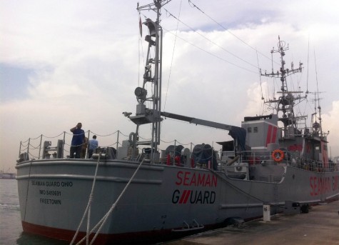 Indian personnel stand on the deck of the Seaman Guard Ohio at a dock in Tuticorin on October 18, 2013. Indian police arrested and questioned 33 people aboard a ship operated by a US anti-piracy firm for carrying guns and ammunition in Indian waters without proper permits, reports said. India's coastguard stopped and detained the ship off the Indian coast on October 12 after discovering the cache of weapons and ammunition, before escorting it to the southern port of Tuticorin. AFP PHOTO/ STR